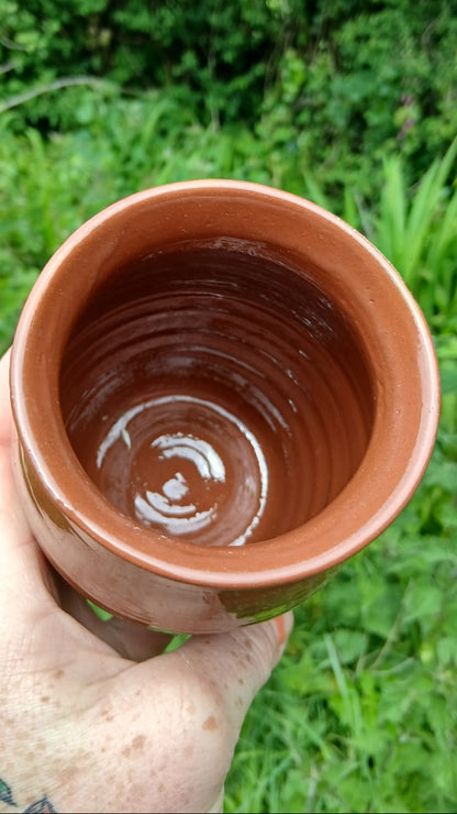A closer view of the rim and inside of a terracotta clay pot with a glossy finish from Ardmore pottery.