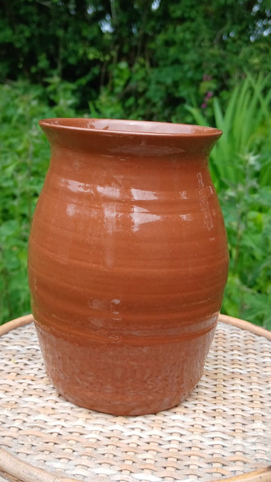 A handmade terracotta clay pot with a glossy finish from Ardmore pottery.