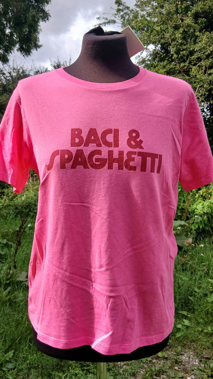 A bright pink short-sleeve t-shirt featuring the words 'BACI & SPAGHETTI' printed across the chest in a dark red font.