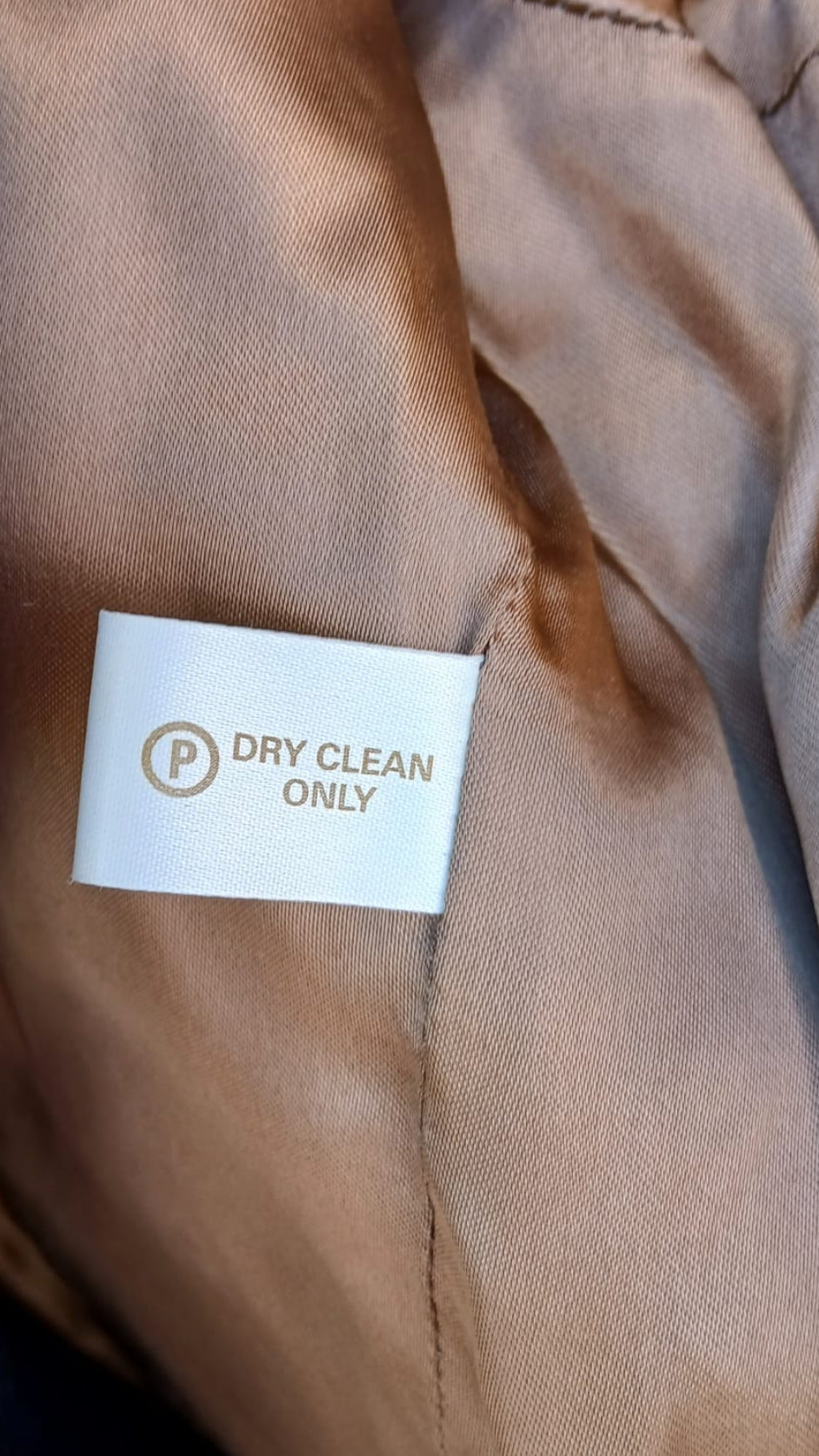 Care tag of Derby House green tweed jacket