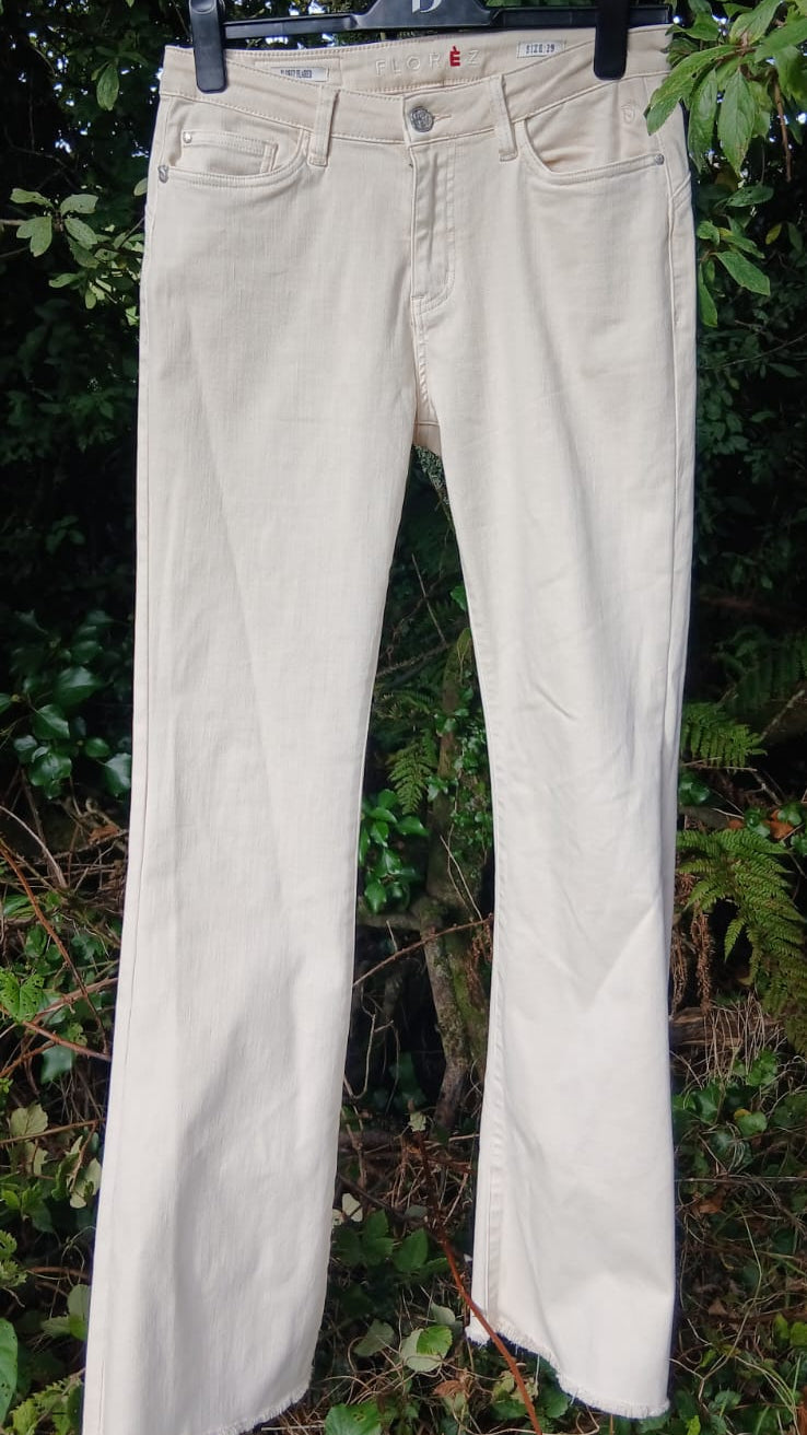A pair of light beige or cream-colored denim jeans by Florèz.