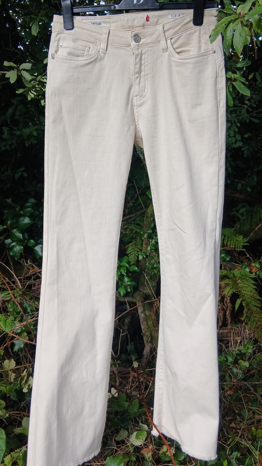 A pair of light beige or cream-colored denim jeans by Florèz.