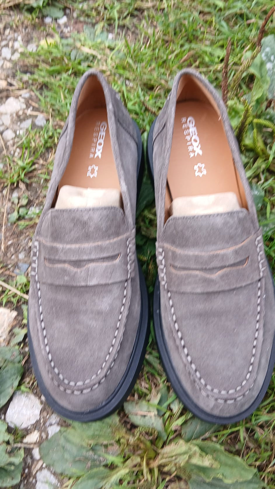 A pair of Geox gray suede moccasins with black soles.