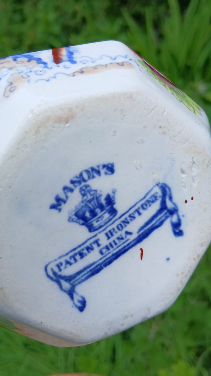 A close-up of the underside of a Mason's white ceramic jug with blue printed text reading 'MASON'S PATENT IRONSTON CHINA' and a crown emblem.