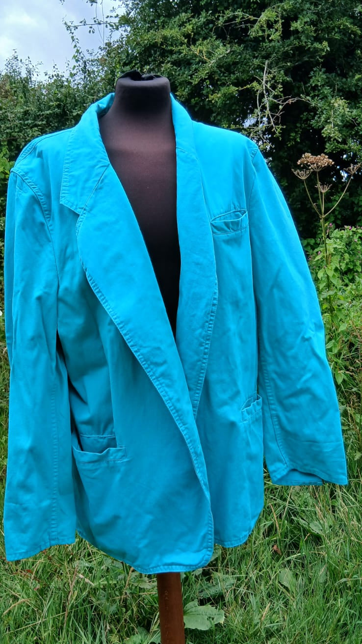 A bright turquoise blue jacket by Mustang clothing.