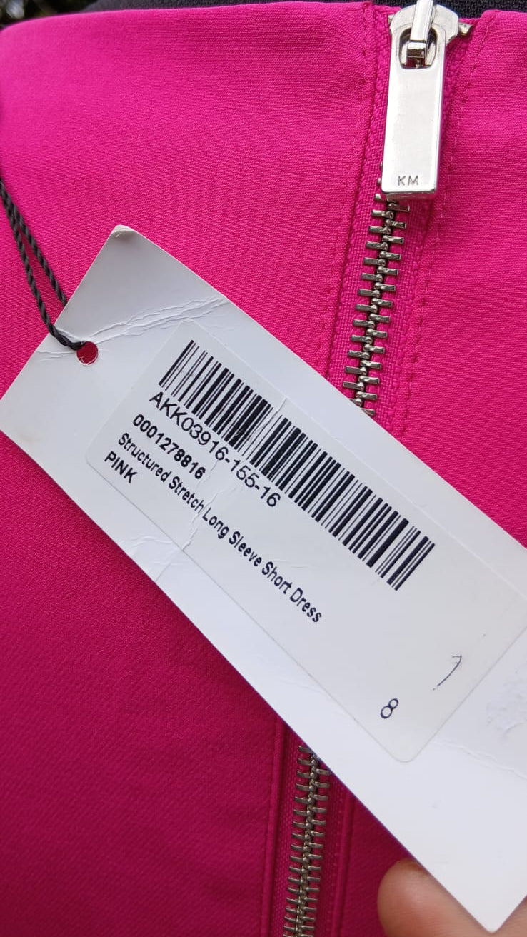Close-up of a Karen Miller pink dress tag information