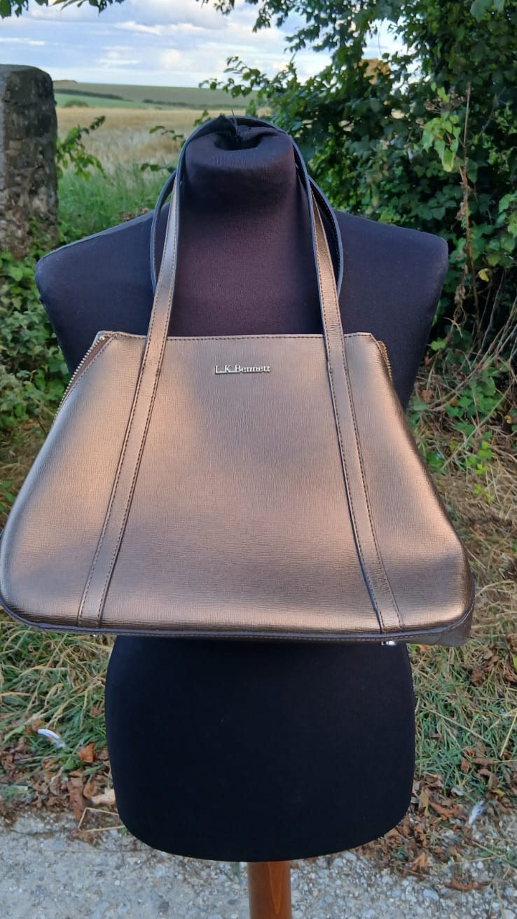 A metallic bronze leather tote bag with a small silver-tone logo plaque by  L.K. Bennett London.