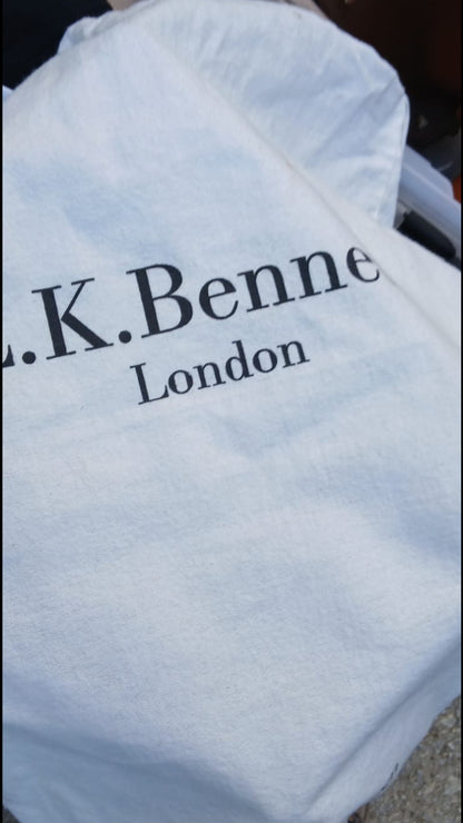 A white fabric dust bag with 'L.K.Bennett' inscription. 