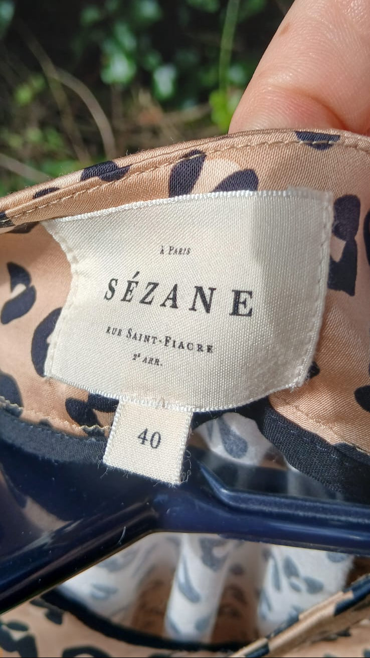 Close-up of the interior label of a Sézane leopard skirt, showing the brand name and size 40.