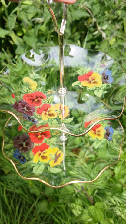 Top view of 2 tier cake stand with pansy pattern and gold rim 