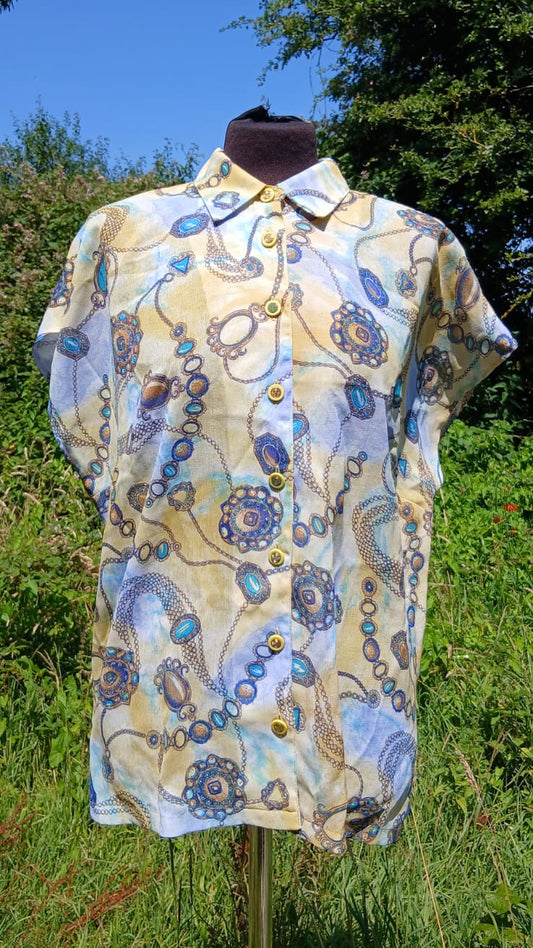 A short-sleeve button-up shirt with a blue and yellow jewelry and chain print.