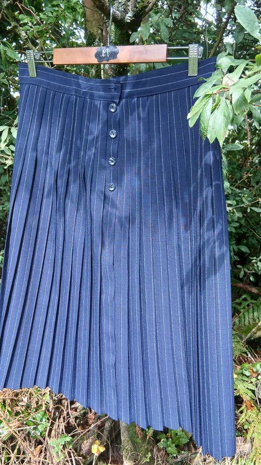 A vintage navy blue pleated skirt with a button front from the St Micheal brand.