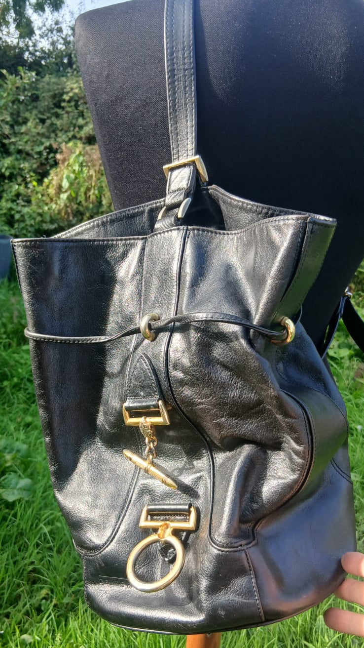 A black leather bucket bag with gold-tone hardware.