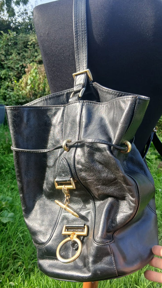 A black leather bucket bag with gold-tone hardware.
