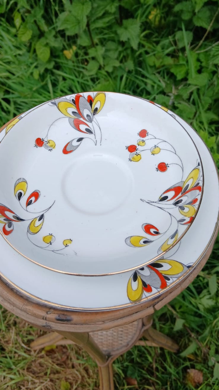 Two Wetley China white bone-china porcelain plates from a teacup trio with a colorful floral and berries hand painted pattern and gold rim.