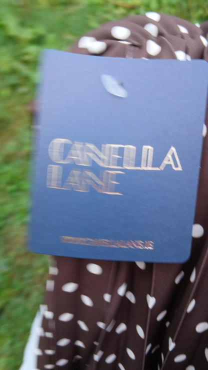 A close-up of a Canella Lane dress tag 